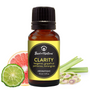 Bottle of 'Clarity' aromatique with ingredients on a white background