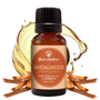 Bottle of sandalwood essential oil with a droplet effect on a white background