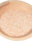 Wooden bowl of pink himalayan salt